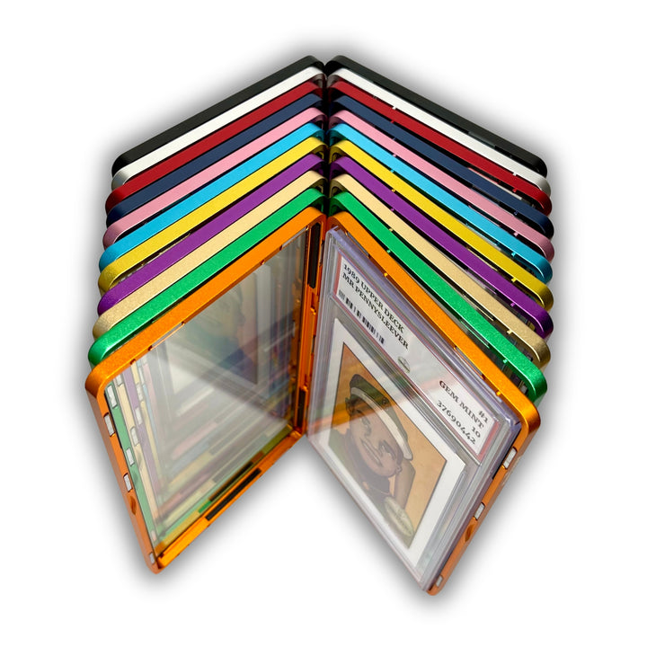 The Pennysleever offers all eleven aluminum case colors—orange, green, gold, purple, yellow, light blue, pink, blue, red, silver, and black—each engineered for PSA and CGC slabs with a strong, secure magnetic closure that keeps your slab safe.