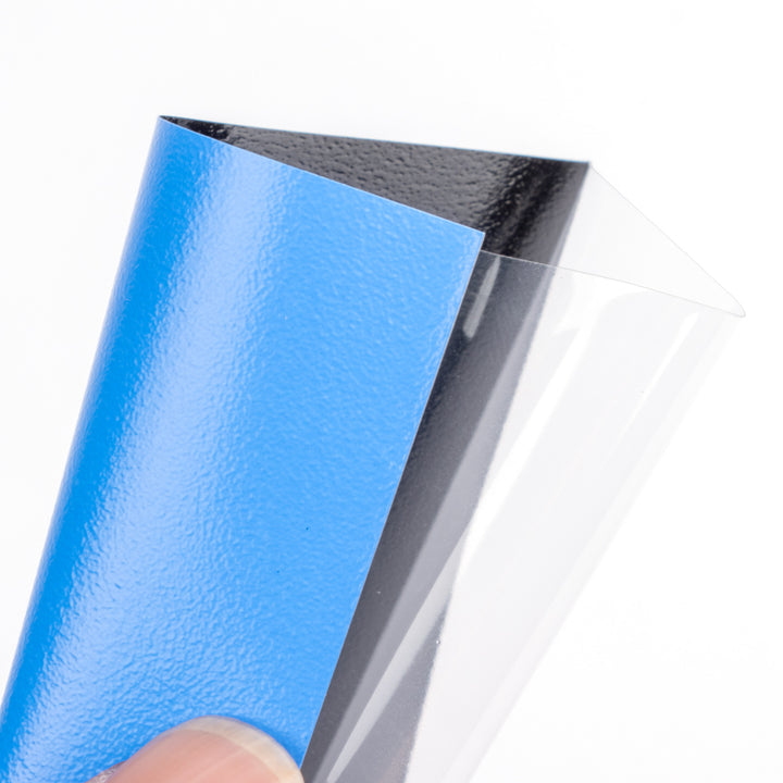 Blue deck protector from The Pennysleever held by a hand on a white background