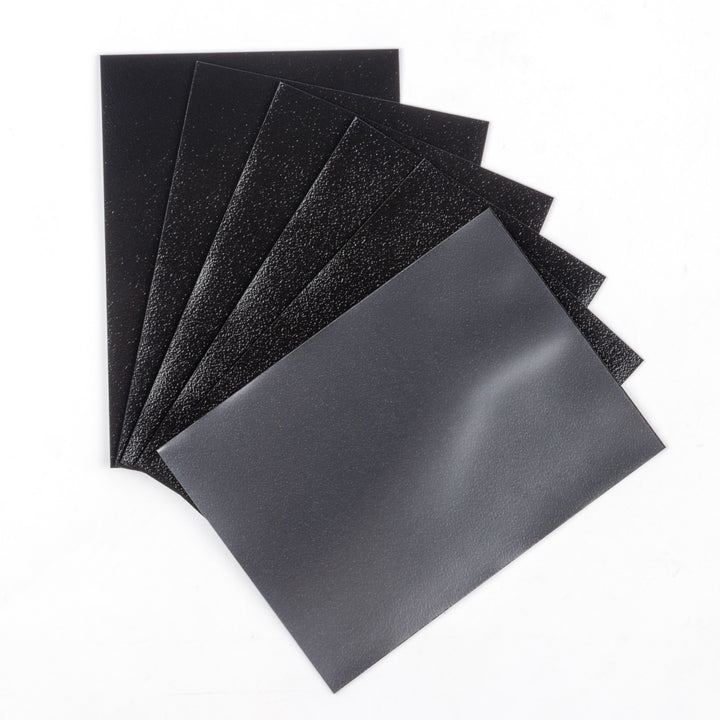 Set of matte black deck protectors from The Pennysleever on a white background