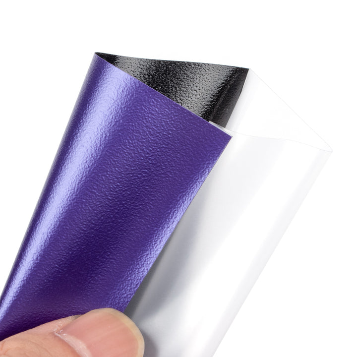 A Purple deck protector sleeve held by a hand on a white background
