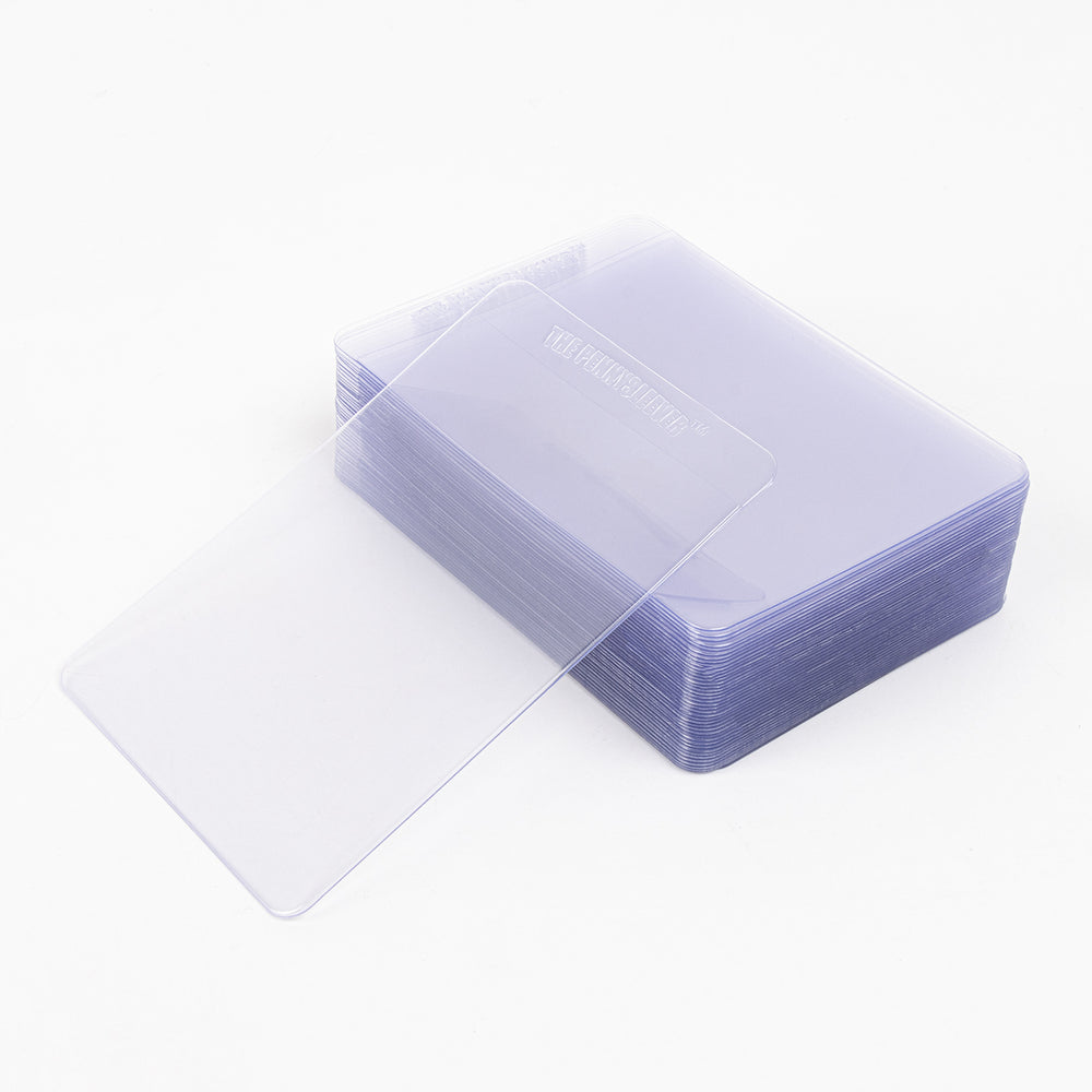 Stack of semi-rigid card holders, with a single semi-rigid card holder resting against it.