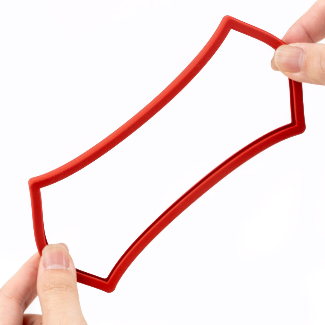 Red silicone slab bumper held by a hand on a white background