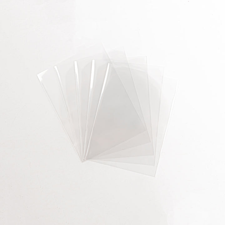 An array of thick card sleeves against a white background.