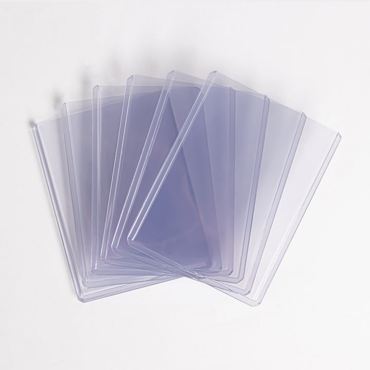 A fanned array of 180 point toploaders against a white background.