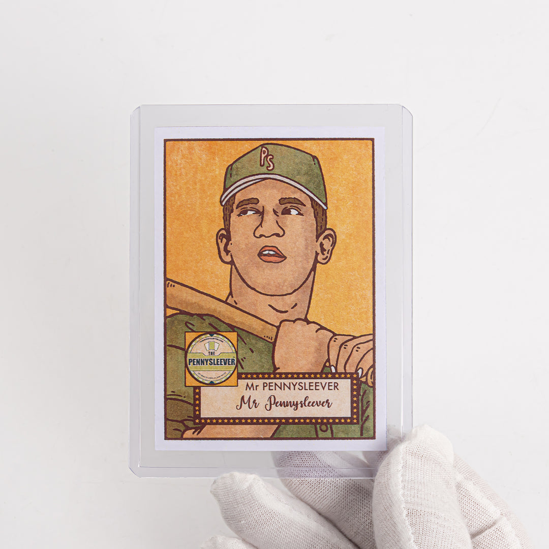 A white gloved hand holding up a baseball card in a 35 point toploader.