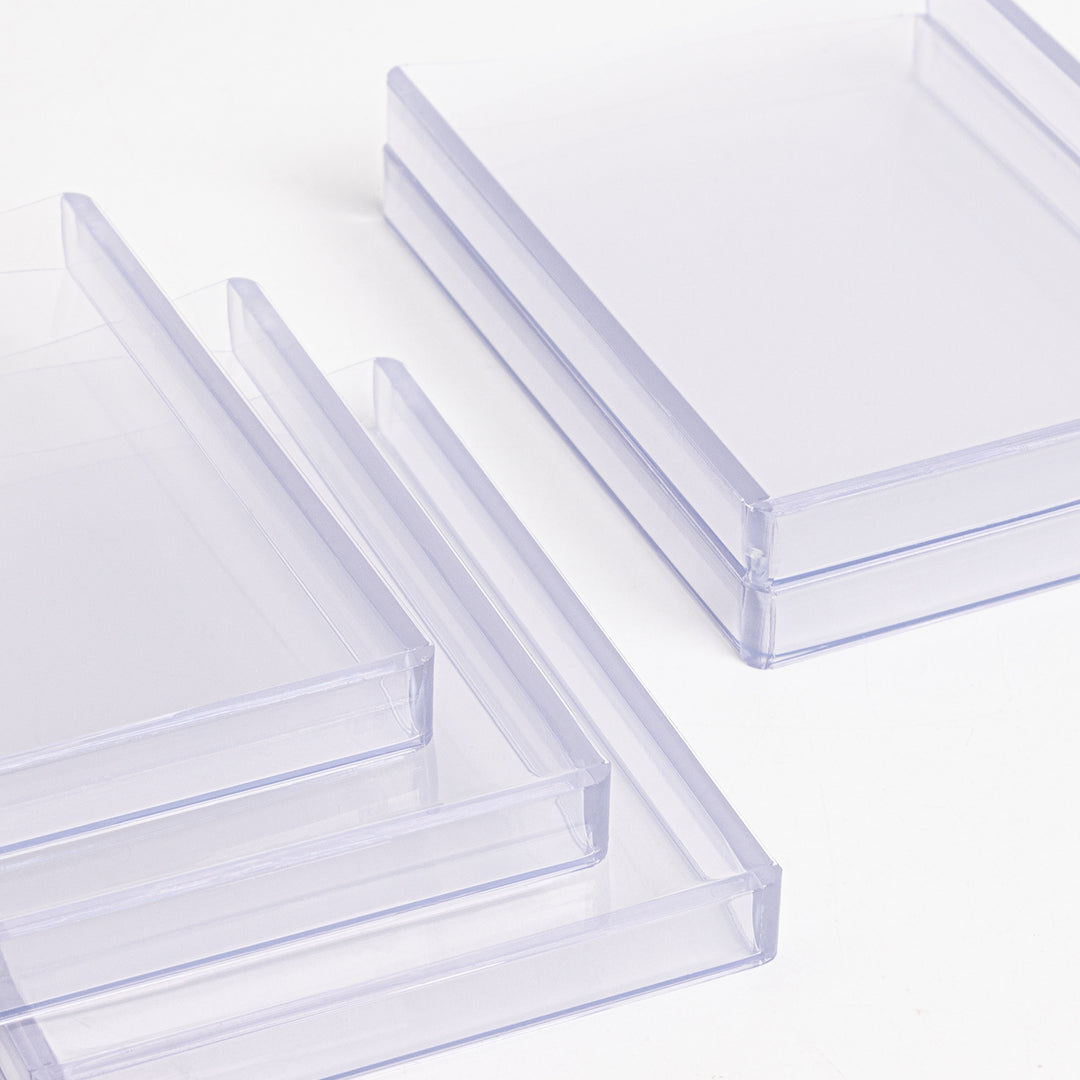 A group of 360 point toploaders lying on a white table.