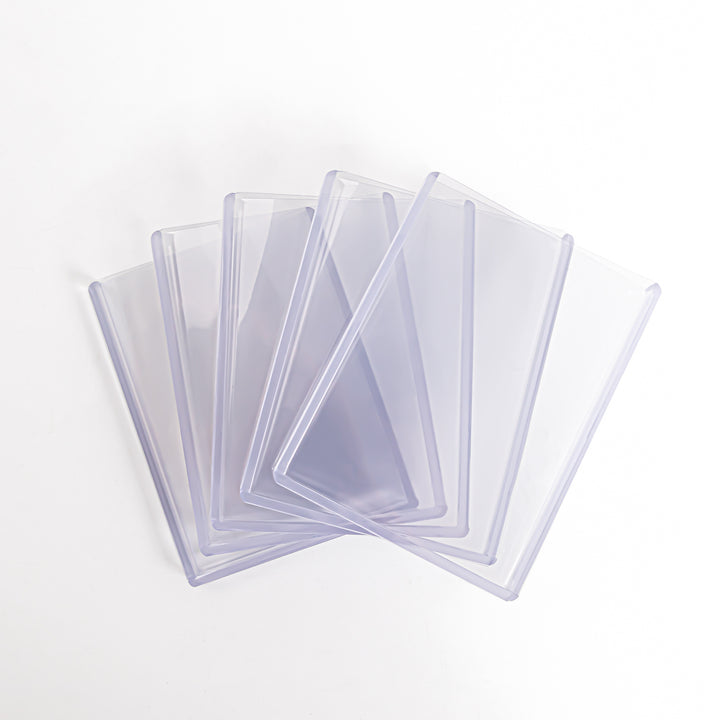 A fan-shaped array of transparent 360 point toploaders against a white backdrop.