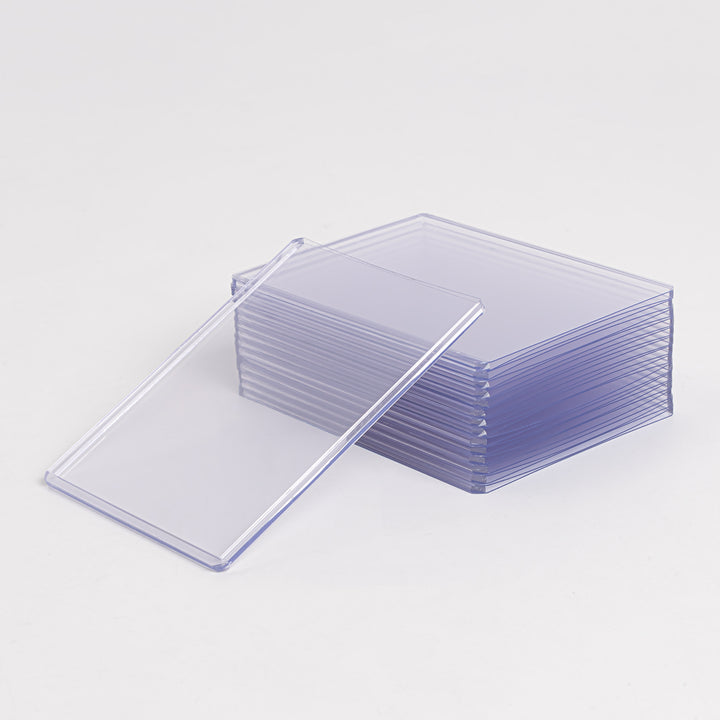 A stack of 100 point toploaders against a white background.