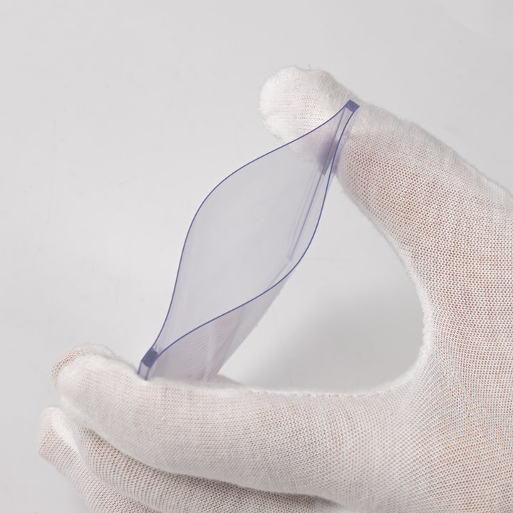 White gloved hand squeezing a 75 point toploader against a white background.